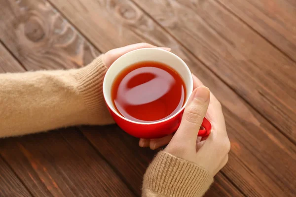 Женщина с чашкой ароматного чая — стоковое фото