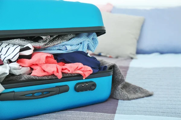 Open packed travel suitcase — Stock Photo, Image