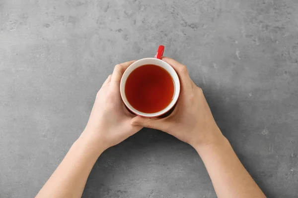 Woman holding cup of aromatic tea — Stock Photo, Image