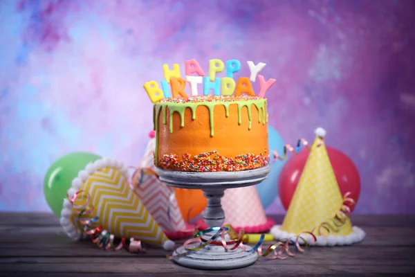 Tasty birthday cake with party hats — Stock Photo, Image