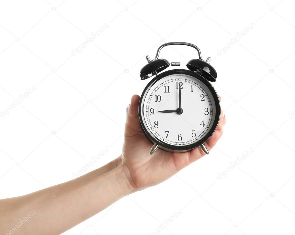 hand holding alarm clock