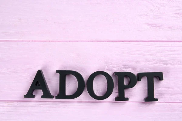 Слово ADOPT из букв — стоковое фото