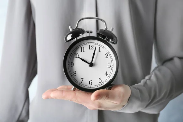 Hands holding alarm clock — Stock Photo, Image