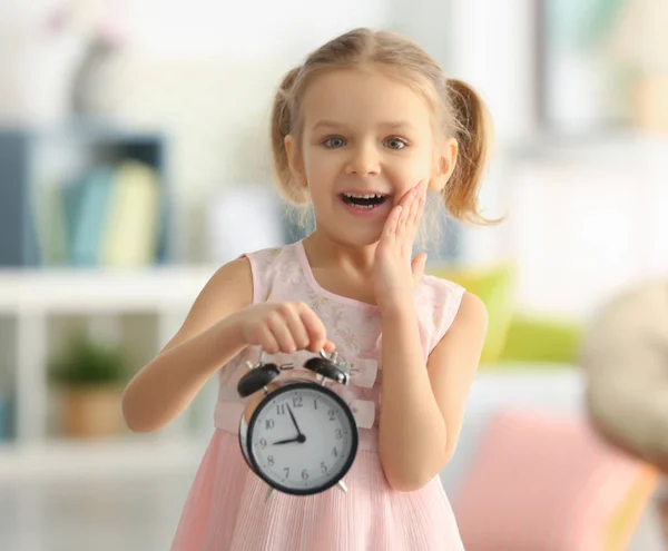 Little girl with alarm clock — Stock Photo, Image