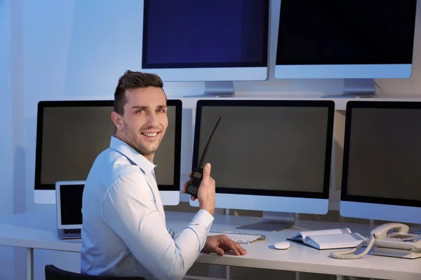 Handsome security guard in surveillance room — Stock Photo, Image