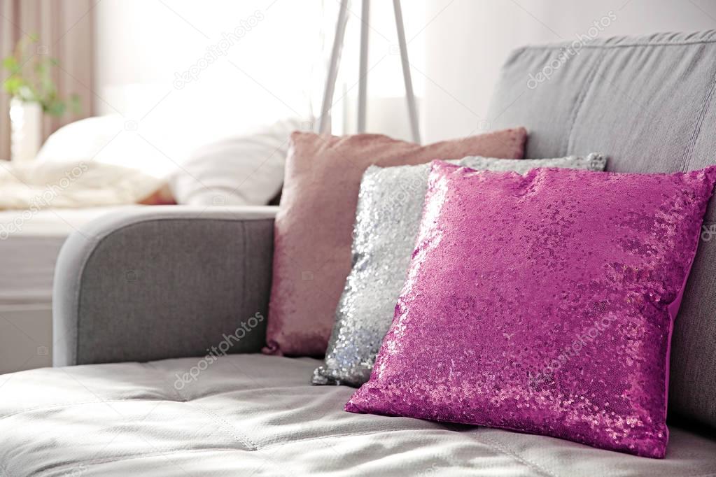 Three shiny decorative pillows