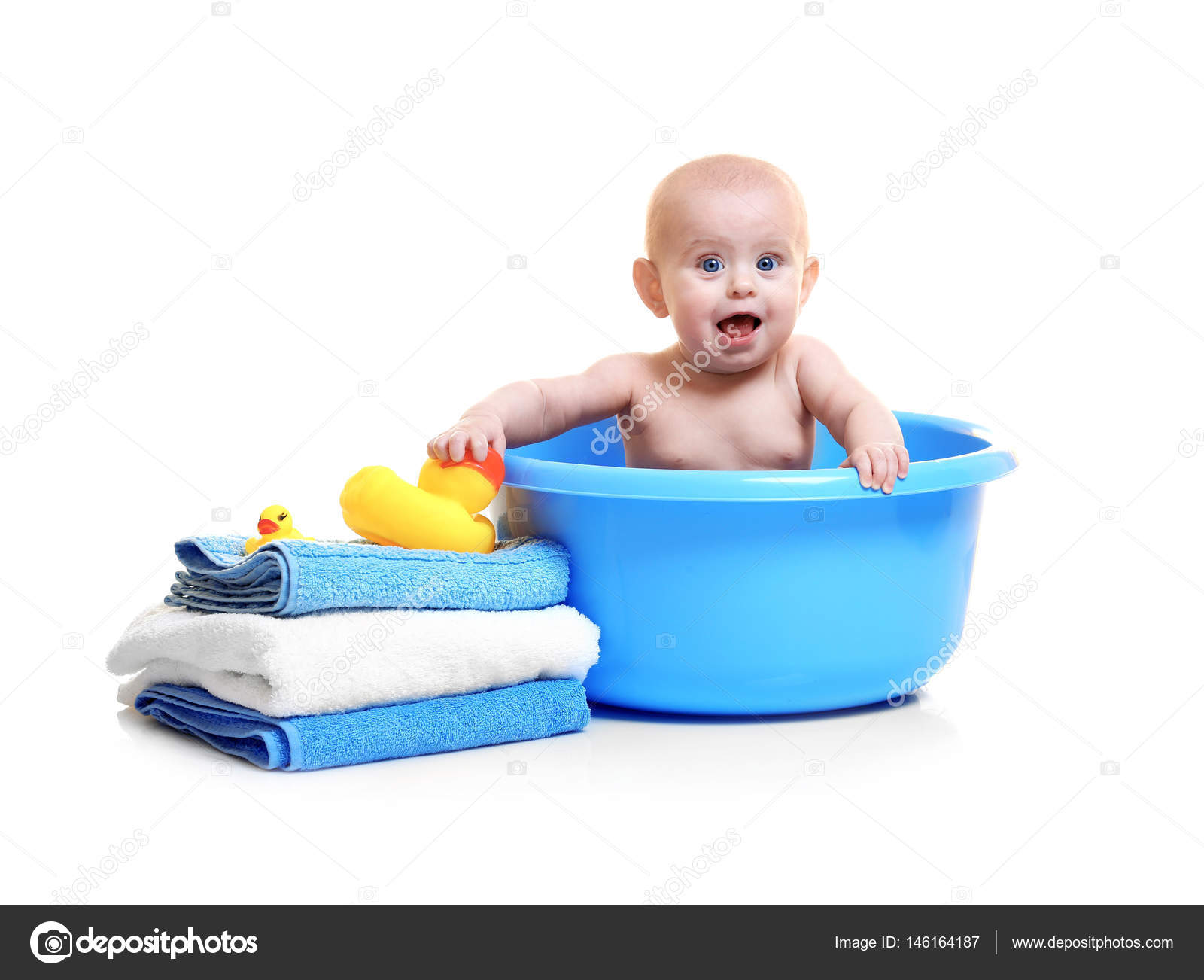 Cute baby in plastic basin Stock Photo by ©belchonock 146164187