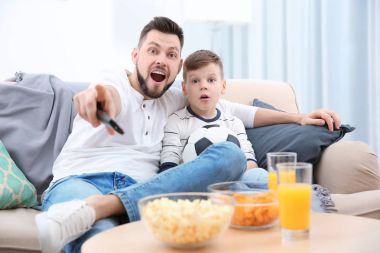 Baba ve oğul evde futbol TV izlerken