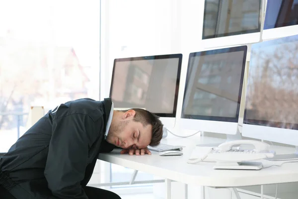 Handsome security guard sleeping in surveillance room — Stock Photo, Image