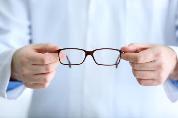 Doctor hands holding glasses — Stock Photo, Image