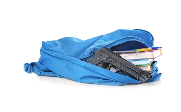 School backpack with books and gun on white background — Stock Photo, Image