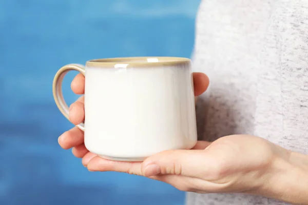 White cup in hands — Stock Photo, Image