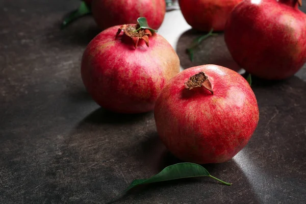 Whole pomegranates on table — Stock Photo, Image