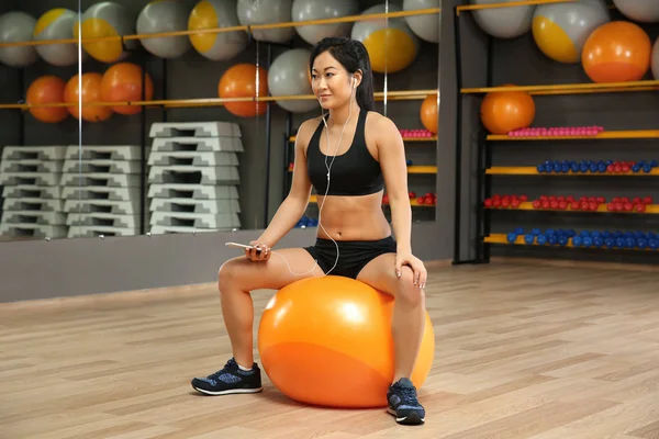 woman training with fit ball in gym