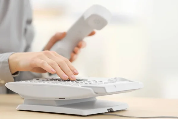 Woman dialing number on telephone — Stock Photo, Image