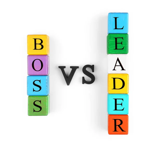 Towers of colorful wooden cubes and black letters forming text BOSS VS LEADER isolated on white — Stock Photo, Image