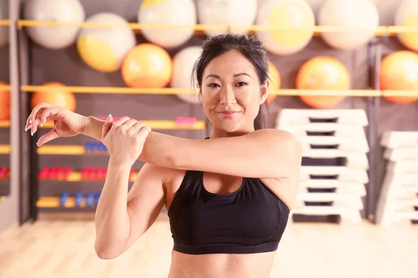 Frau wärmt sich für Training im Fitnessstudio auf — Stockfoto