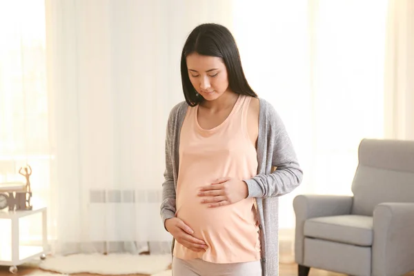 Pregnant Asian woman at home — Stock Photo, Image
