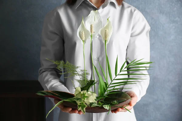 Woman holding floral composition — Stock Image Woman holding floral composition Stock Photo