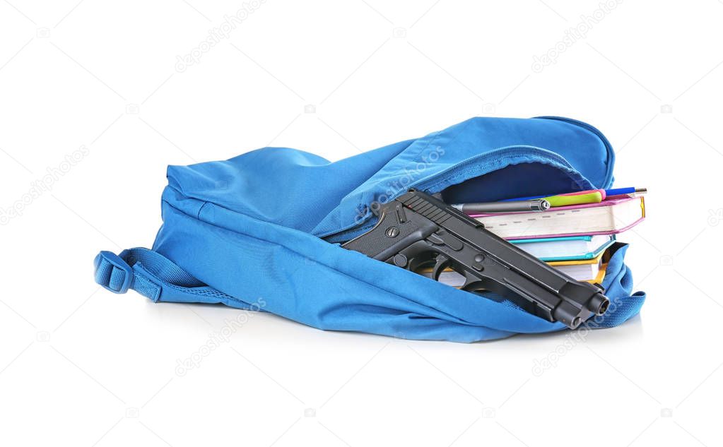 School backpack with books and gun on white background