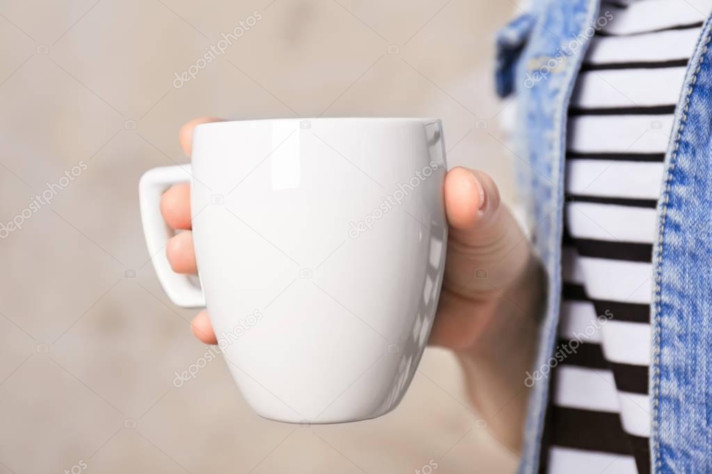 Blank white cup in hand
