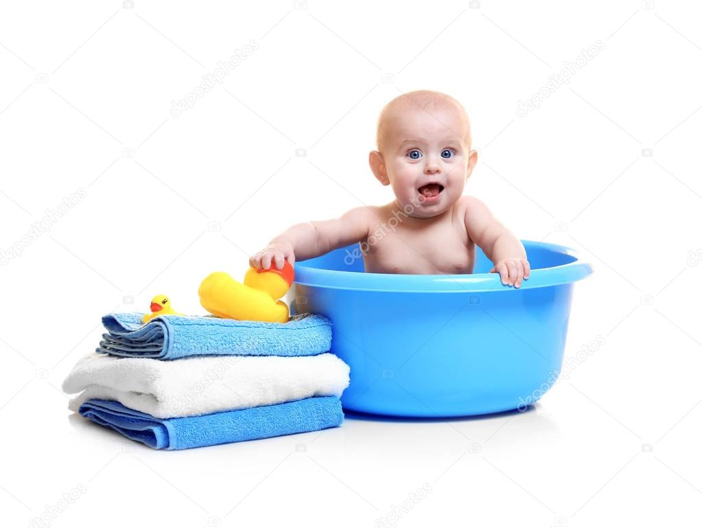 Cute baby in plastic basin