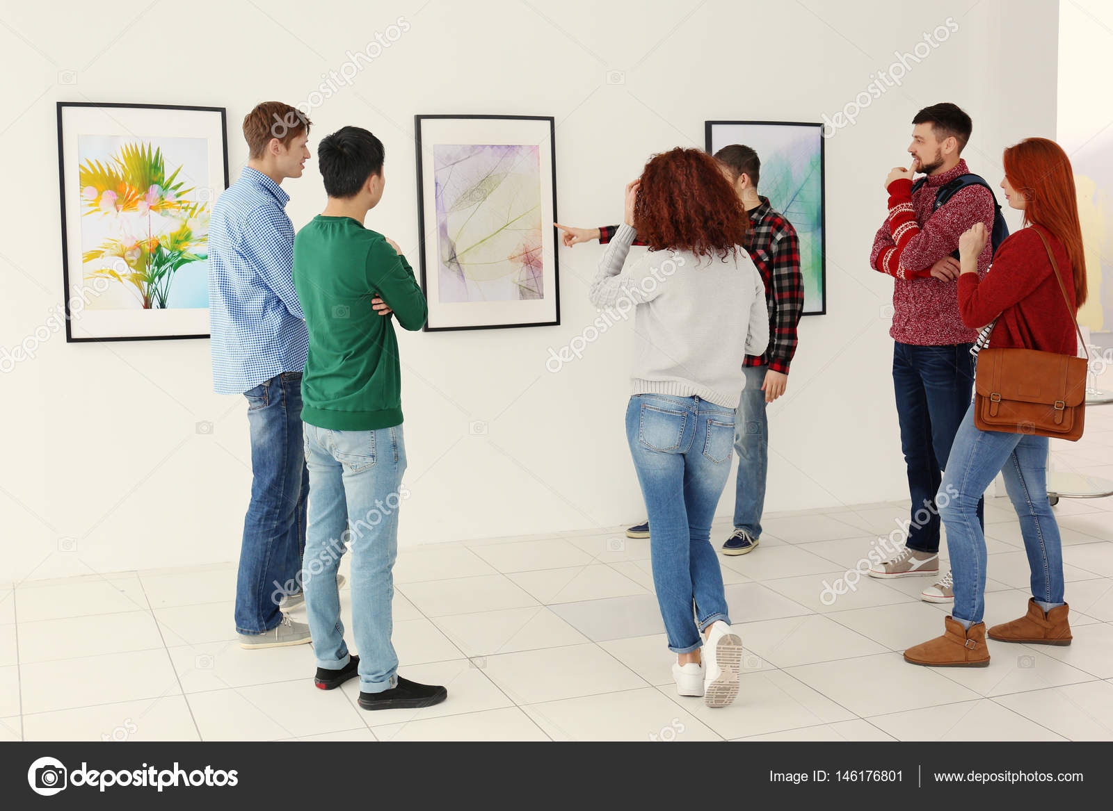 Young people in modern art gallery hall Stock Photo by ©belchonock 146176801
