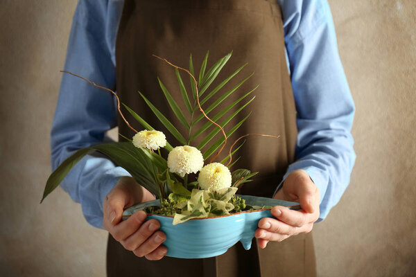 Woman holding floral composition