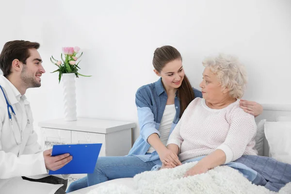 Beautiful girl with grandmother visiting doctor — Stock Photo, Image