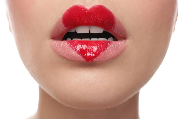 Beautiful young woman with heart painted on lips — Stock Photo, Image