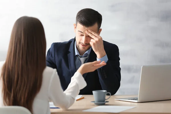 HR manager interviewing young man in office