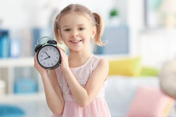 Little girl with alarm clock — Stock Photo, Image