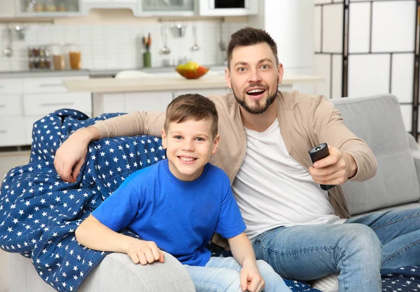 Father and son watching sports on TV at home — Stock Photo, Image