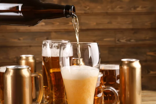 Pouring beer from bottle into glass
