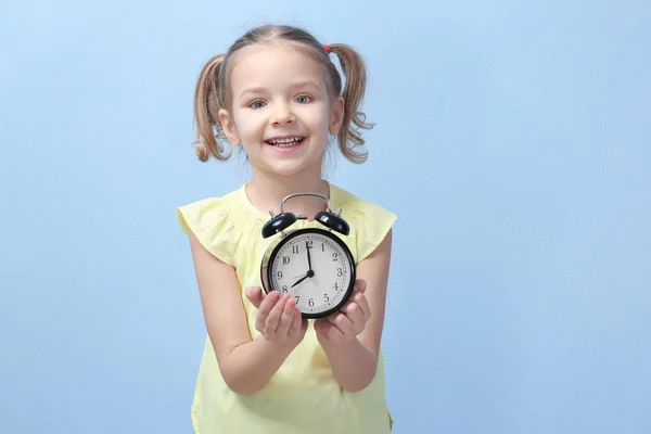 Little girl with alarm clock — Stock Photo, Image