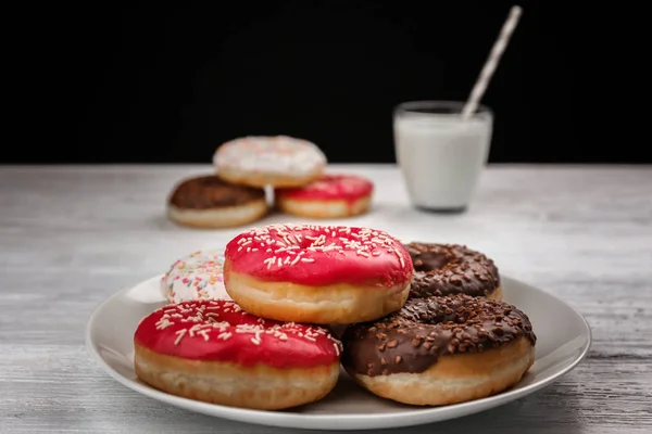 Tasty donuts with cup of milk — Stock Photo, Image