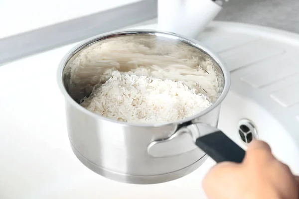 Woman rinsing rice — Stock Photo, Image