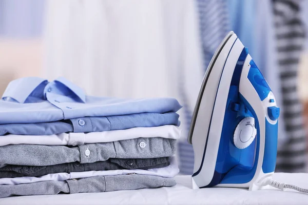 Electric iron and pile of clothes