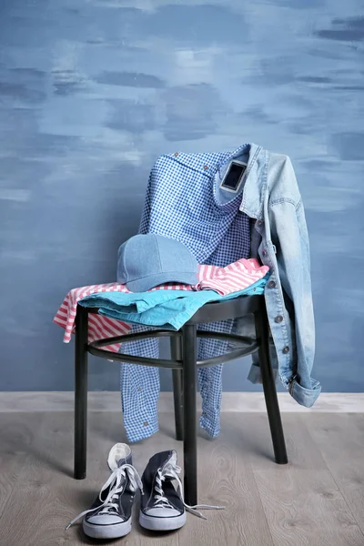 Pile of clothes on wooden chair