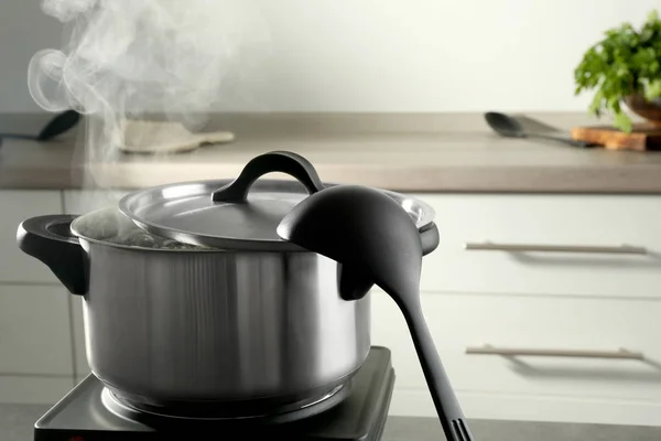 Metal saucepan with boiling water — Stock Photo, Image