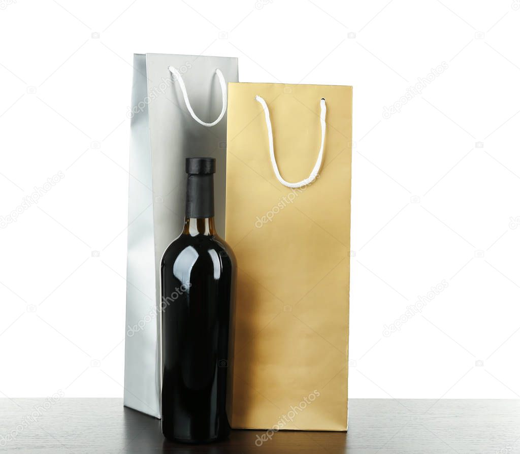 Wine bottle and gift bags on white background
