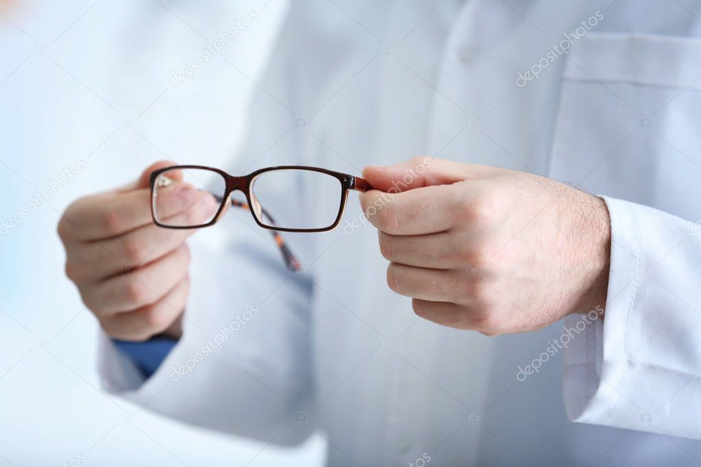 Doctor hands holding glasses