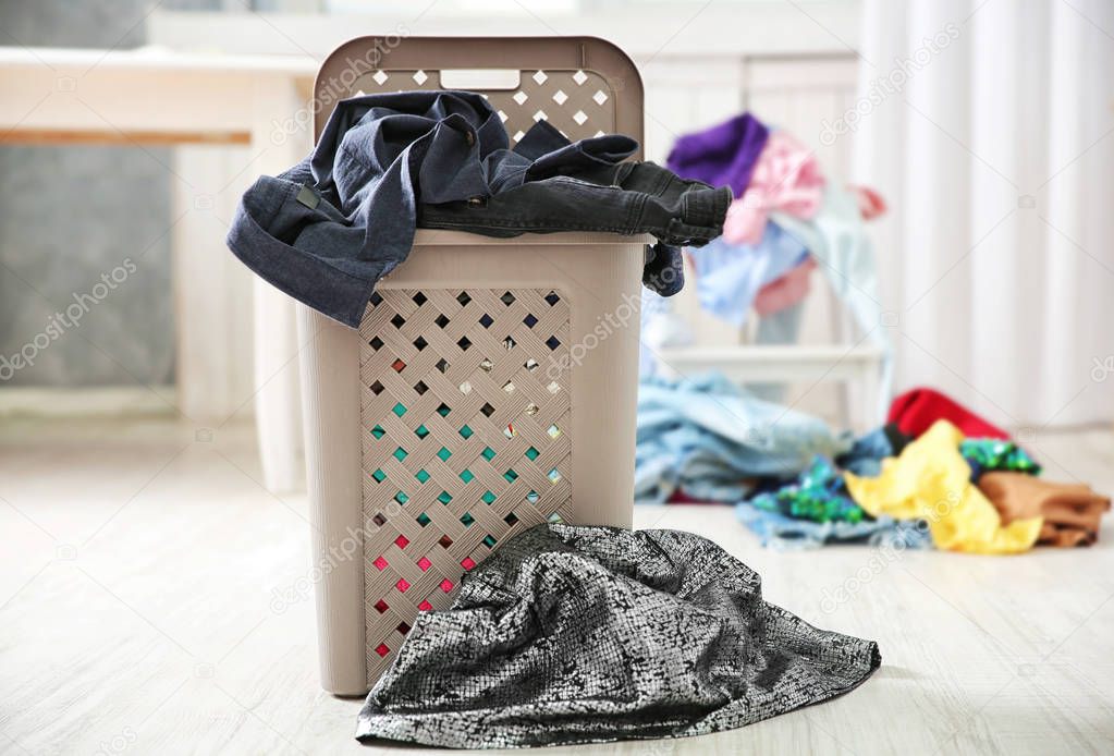 lothes in plastic laundry basket  