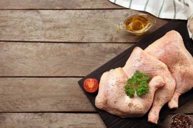 Raw chicken legs with spices clipart