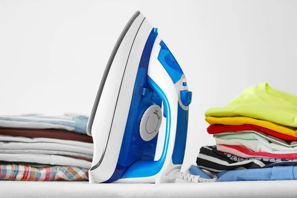 Iron and clean clothes on board — Stock Photo, Image