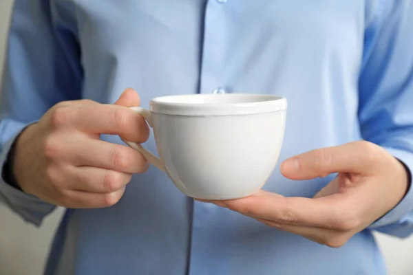 White cup in hands — Stock Photo, Image