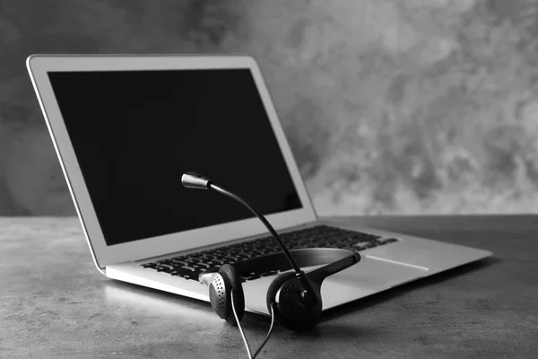 Modern laptop and headphones — Stock Photo, Image