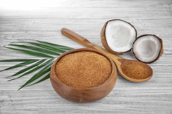 Bowl and spoon of brown sugar with coconut — Stock Photo, Image