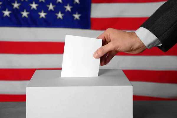 Male hand putting voting ballot — Stock Photo, Image