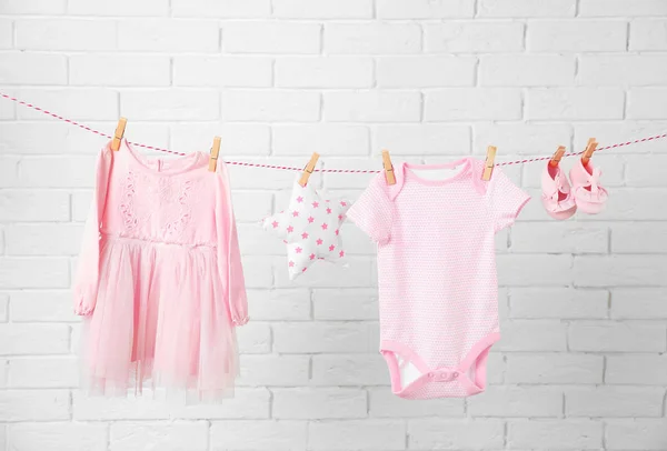 Clothesline with hanging baby clothes — Stock Photo, Image
